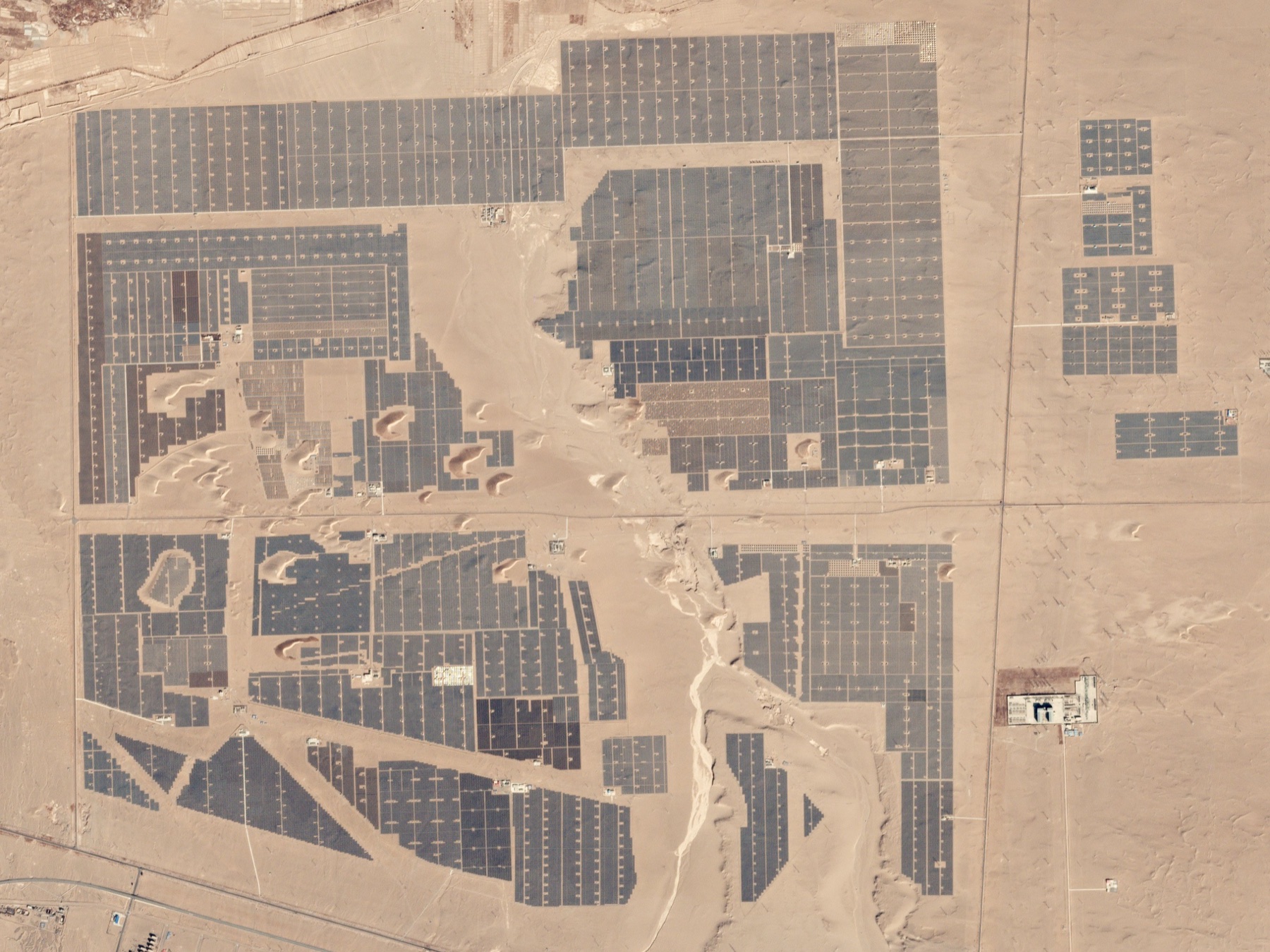 A satellite view of rectangular solar arrays amid the desert near Golmud, China.